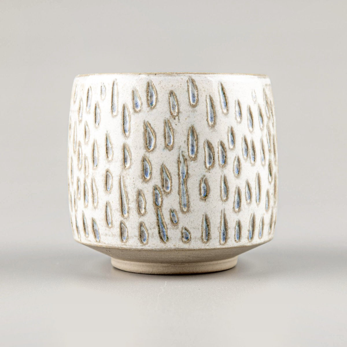 Handcrafted ceramic espresso cup with droplet pattern, perfect for coffee lovers and interior design accents.
