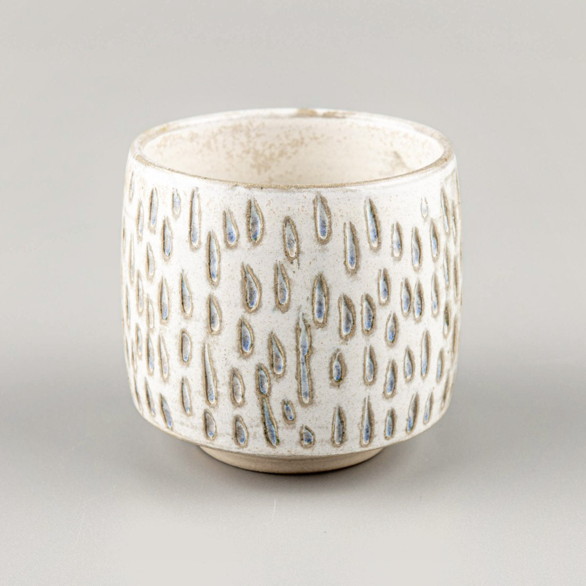 Artisan ceramic espresso cup with carved white clay texture for fine dining and boutique hotel settings.