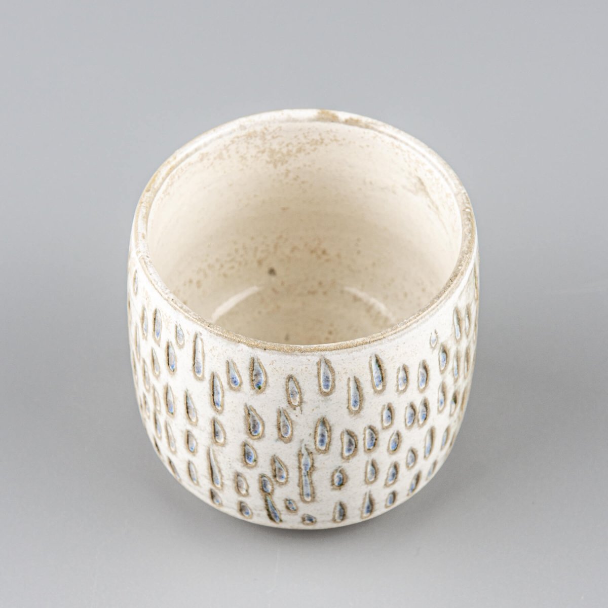 Ceramic espresso cup with carved surface, perfect for coffee rituals in home or boutique hotel.