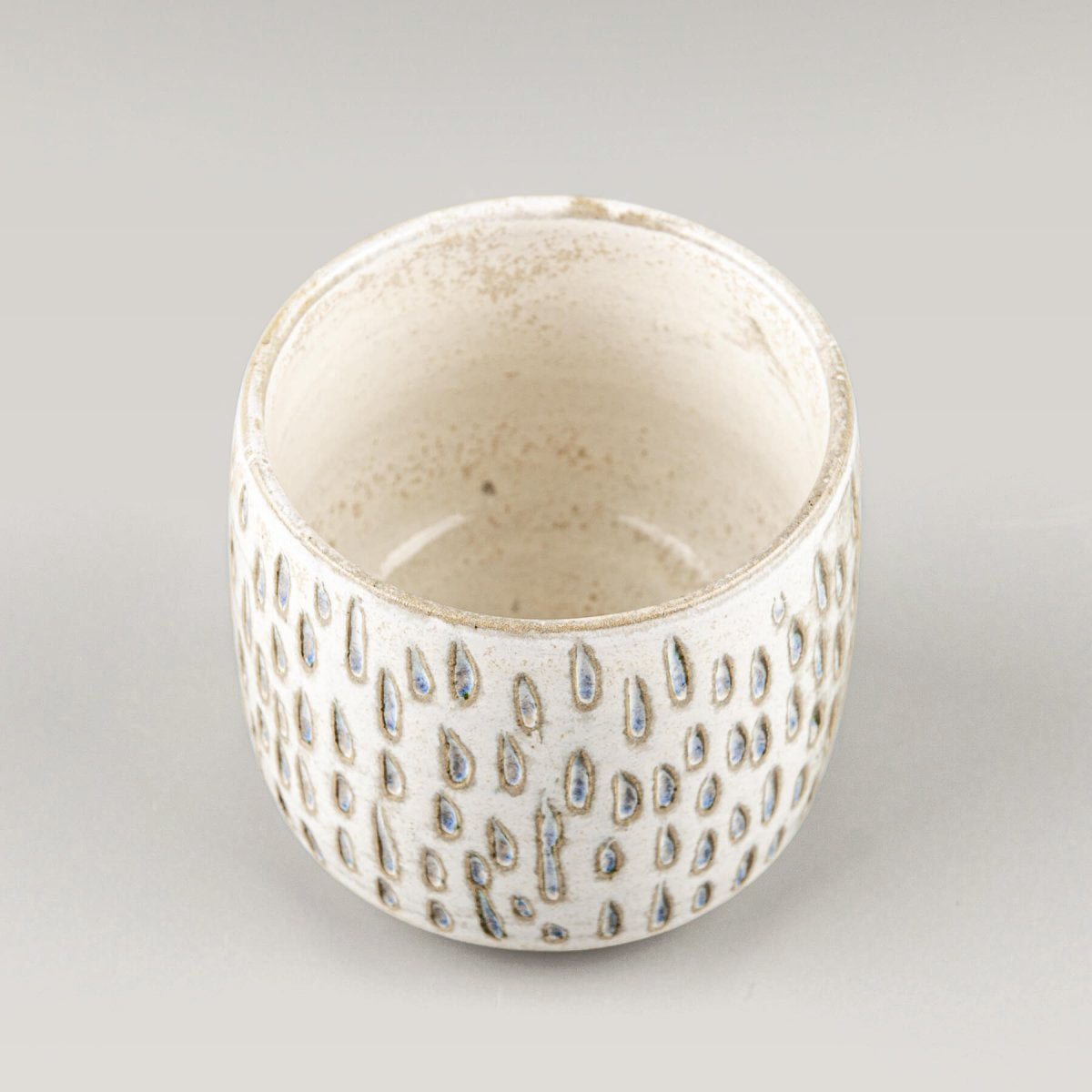 Ceramic espresso cup with carved surface, perfect for coffee rituals in home or boutique hotel.