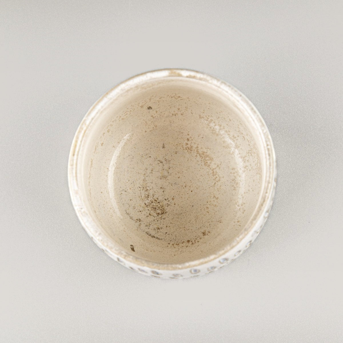 Top view of ceramic espresso cup with handmade droplet design, ideal for collectible kitchenware.