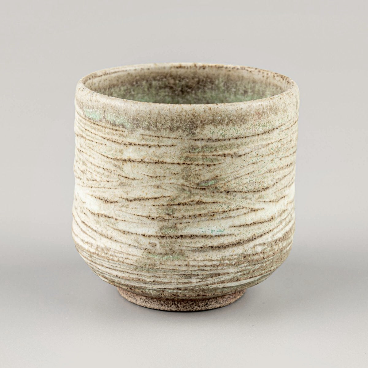 Artisan ceramic mug with layered glazes, ideal for fine dining and collectible pottery.