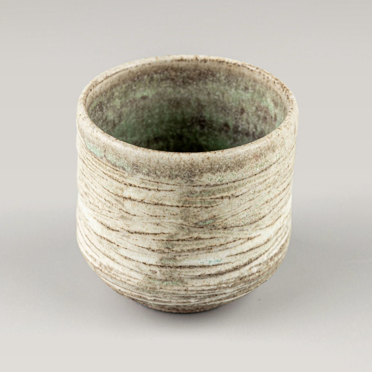 Rustic handmade mugs with earthy tones, perfect for boutique hotels and interior design.