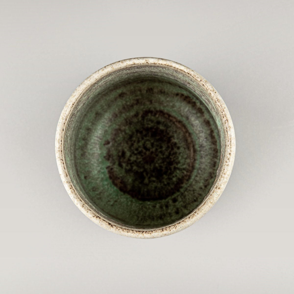 Top view of artisanal ceramic mug with textured glaze for coffee, tea, or matcha tea rituals.