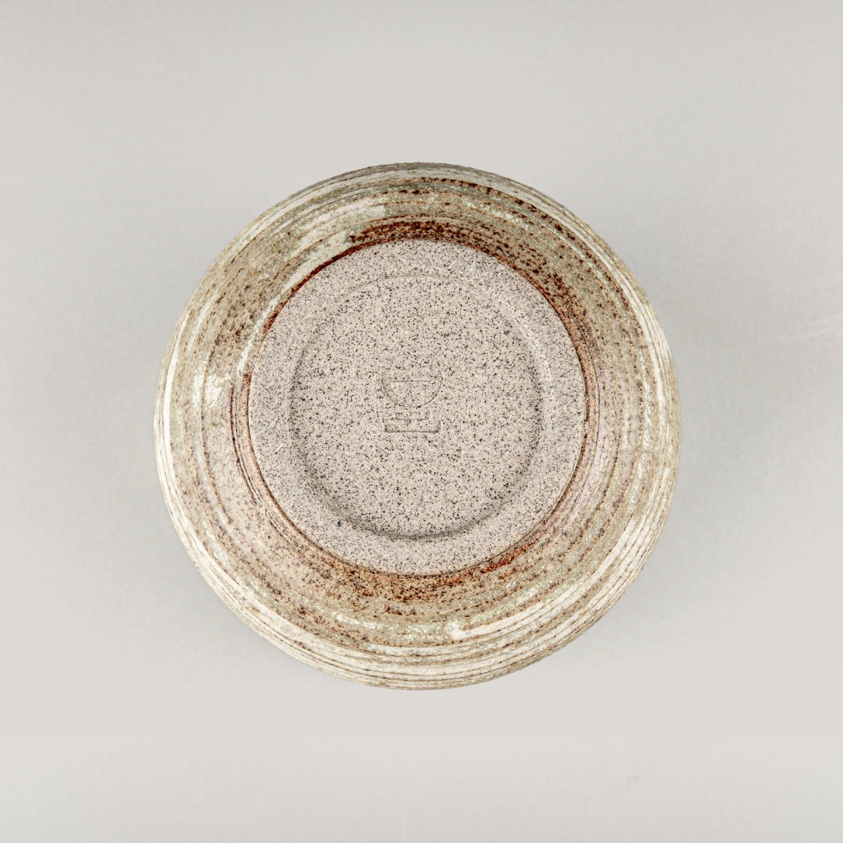 Base view of handmade ceramic mug, showcasing craftsmanship and durable stoneware design.