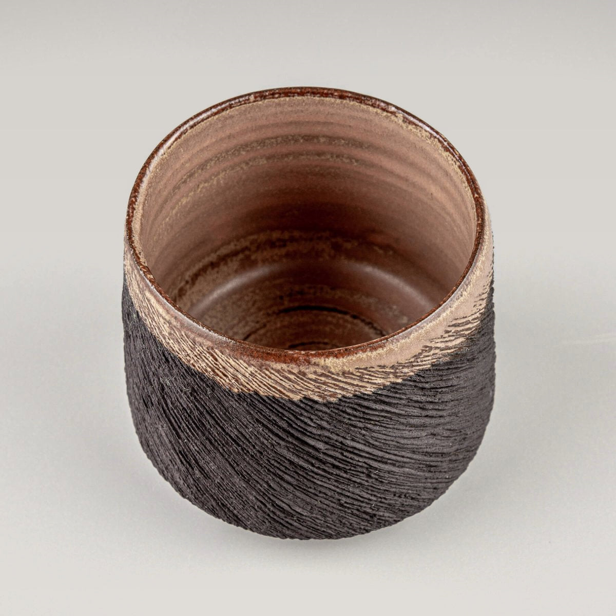 Top view of pottery mug with smooth glazed interior and textured exterior, ideal for kitchenware, and restaurants