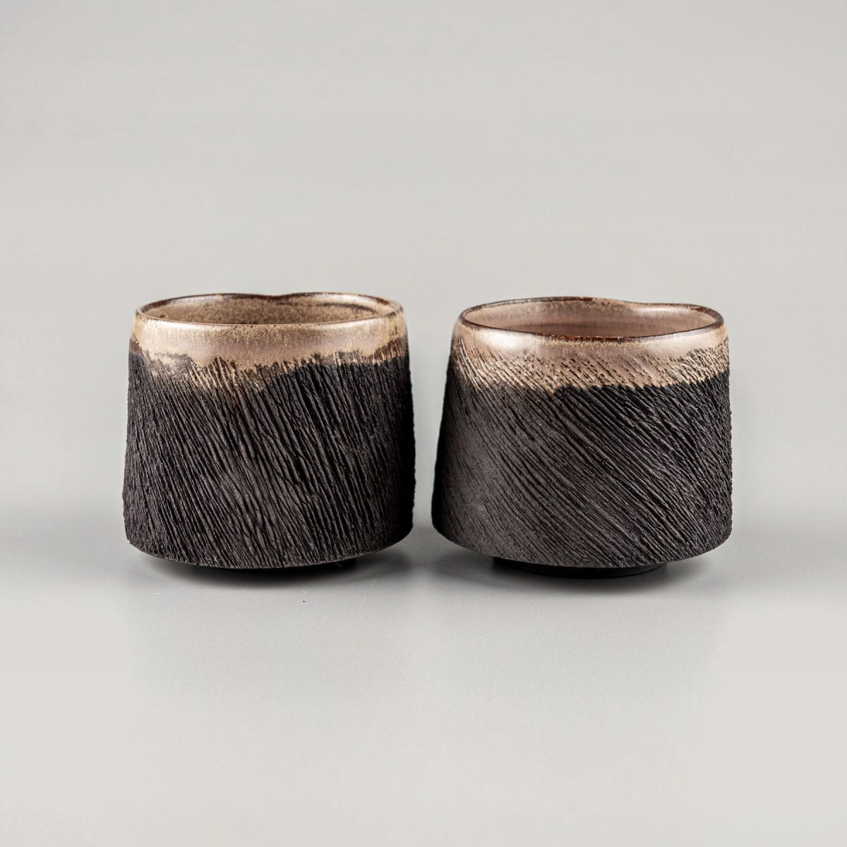 Rustic pottery mugs set with semi-gloss glaze interior, ideal for boutique hotel or collectible pottery tableware.