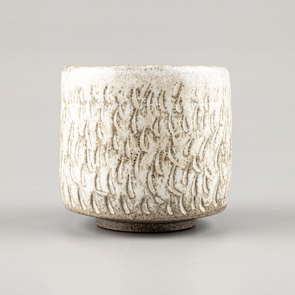 Unique ceramic espresso cup with hoof-like base, matte glaze, and artisan craftsmanship.