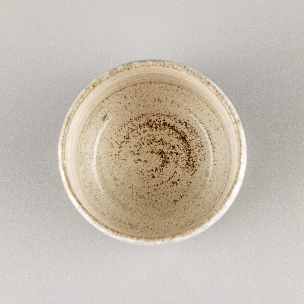 Top view of handmade ceramic espresso cup with natural matte glaze and artisan pottery finish.