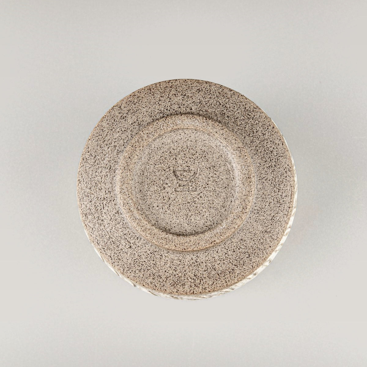Base of artisanal ceramic espresso cup showcasing collectible pottery craftsmanship.