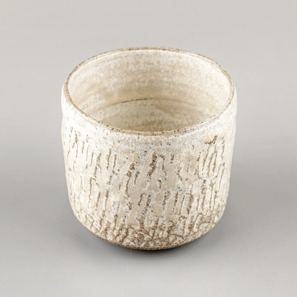 Espresso cup handmade from stoneware clay with fine carved details and matte finish.