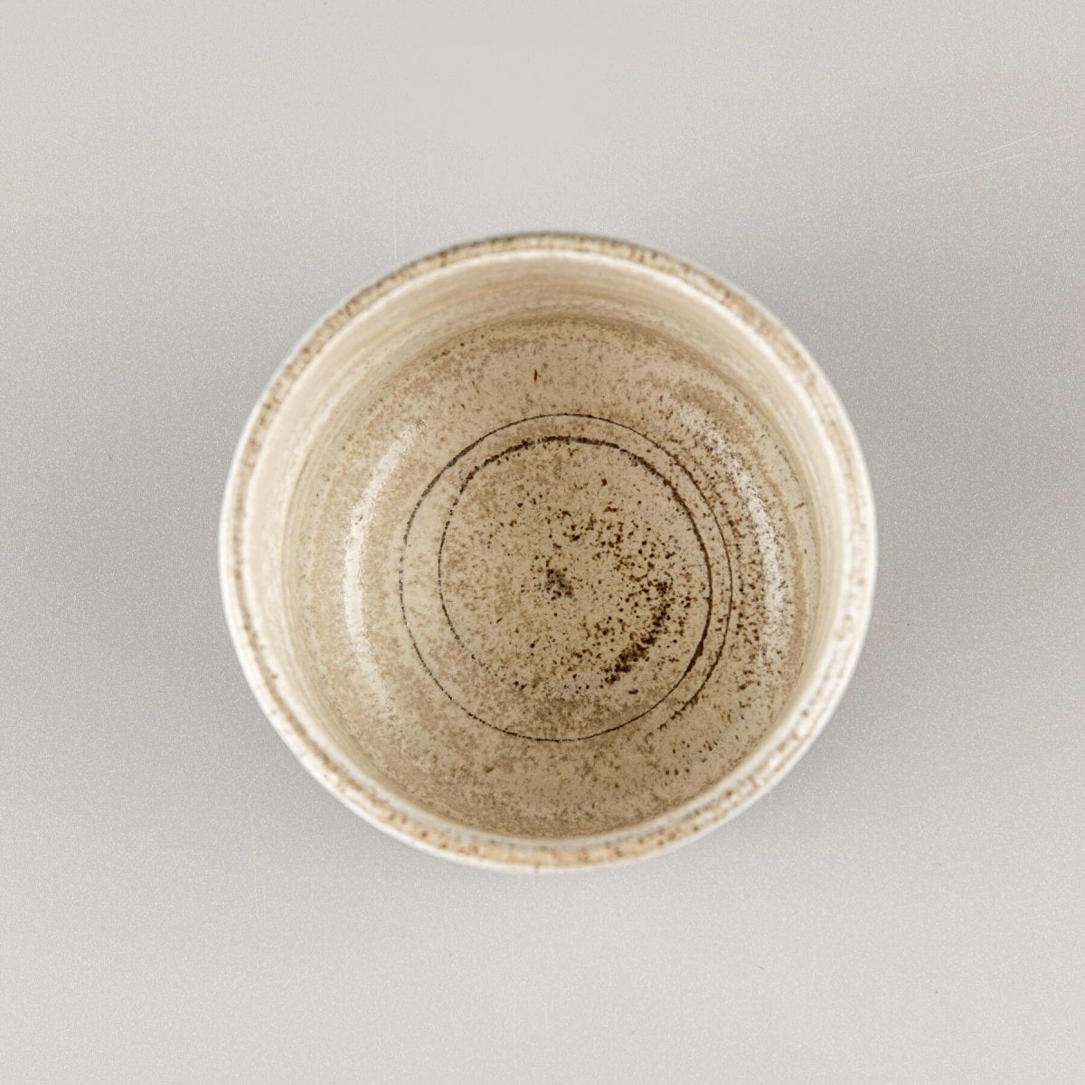 Top view of a ceramic espresso cup with a minimalist, handmade design for restaurants and homes.