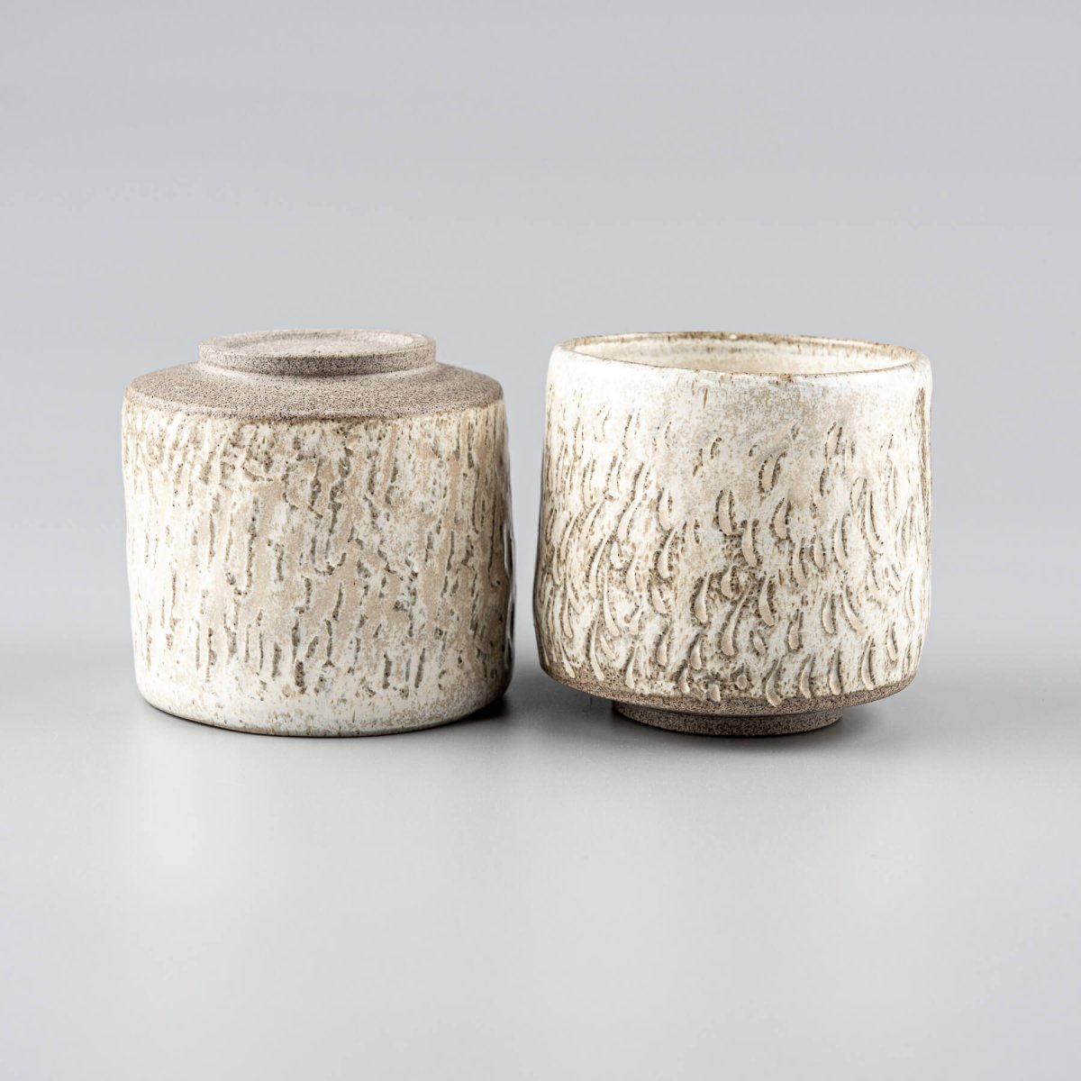 Set of handmade ceramic espresso cups, textured and glazed for collectible kitchenware.
