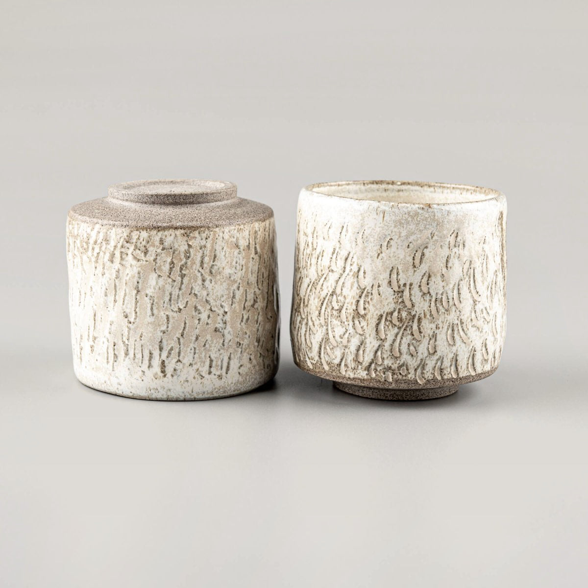 Set of handmade ceramic espresso cups, textured and glazed for collectible kitchenware.