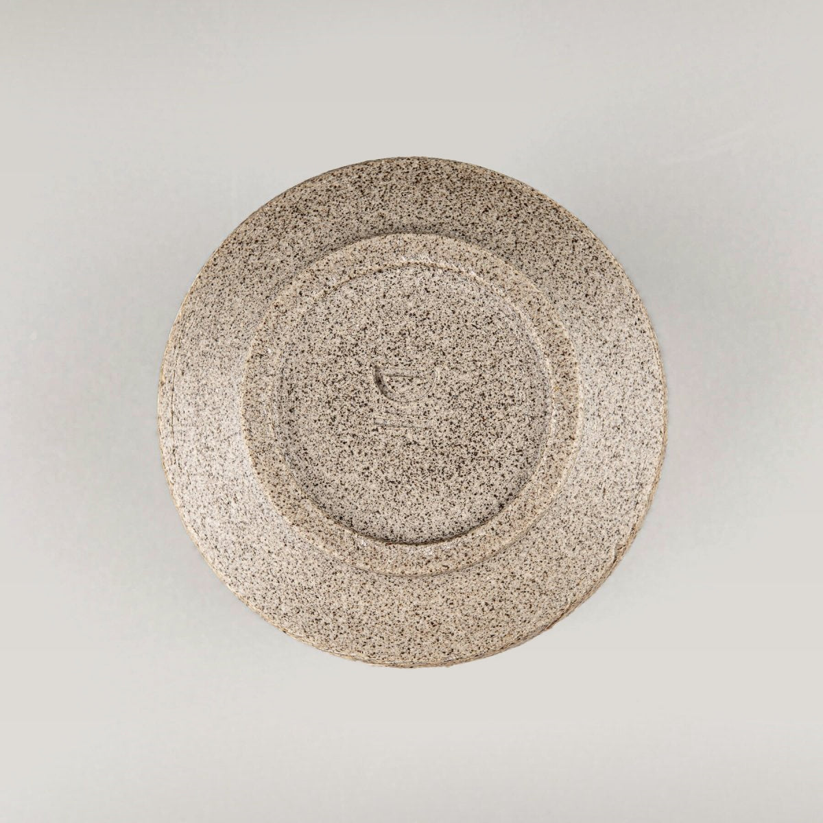 Handmade ceramic mug base with textured stoneware finish, durable collectible pottery for fine dining.