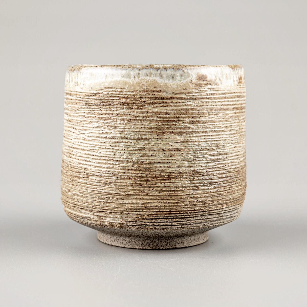 Handmade ceramic mugs with rustic carving and matte glaze, perfect for tea, coffee, or matcha rituals.