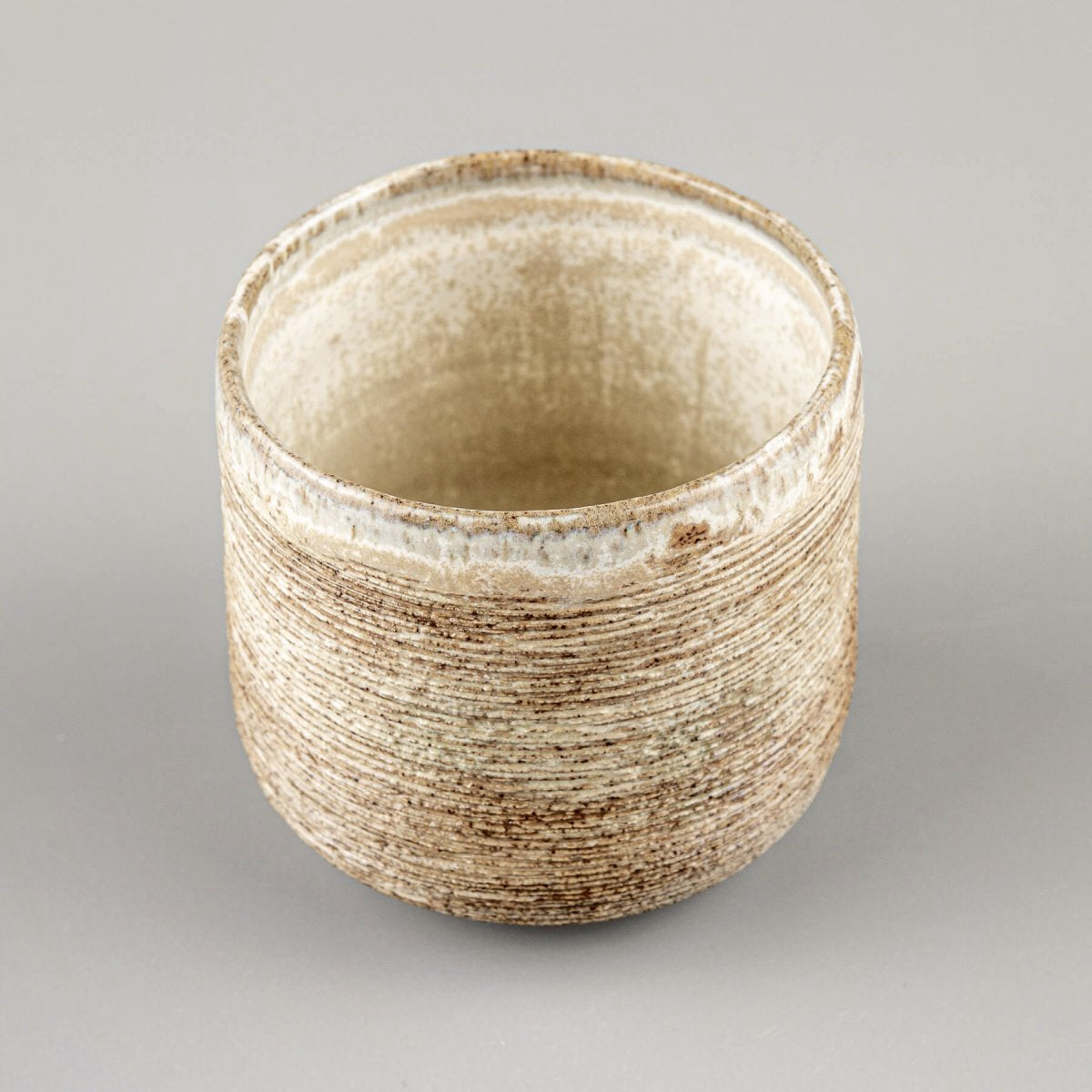 Handmade ceramic mugs with earthy tones and matte glaze, perfect for homes, hotels, and restaurants.