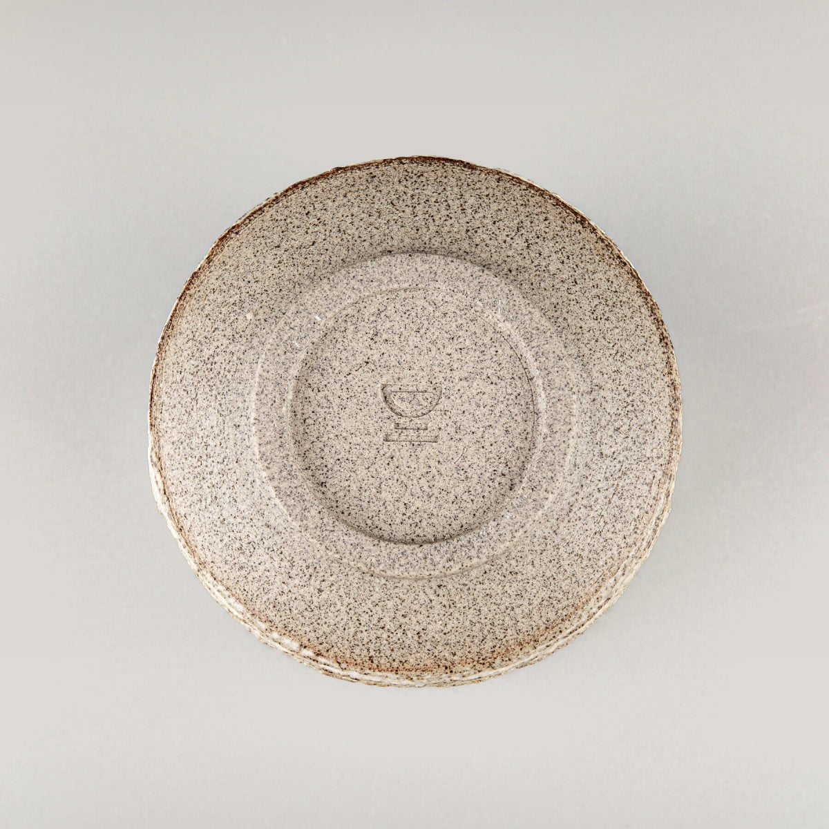 Base of stoneware pottery mug, showcasing limited edition handmade tableware.
