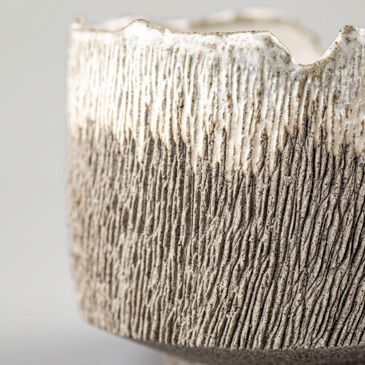 Close-up of textured stoneware coffee cup exterior for interior design and collectible pottery.