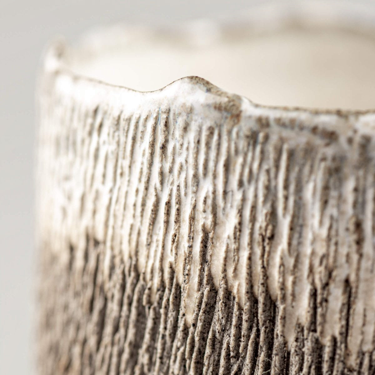 Textured handmade coffee cup with glazed interior, perfect for culinary presentation.
