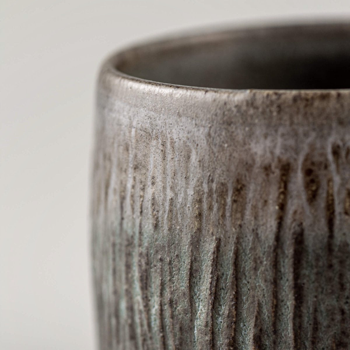 Artisanal stoneware coffee cups with carved details, perfect as a wedding gift or handmade collectible décor.