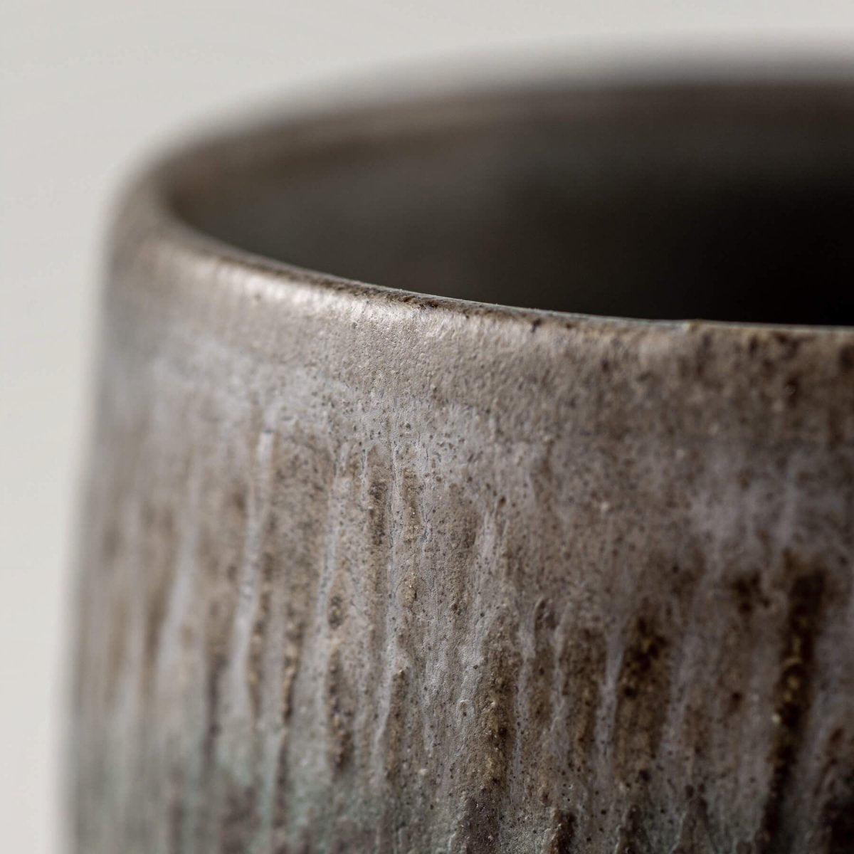 Elegant handmade coffee cups from dark clay with carved design, versatile for restaurants, décor, or gifting.