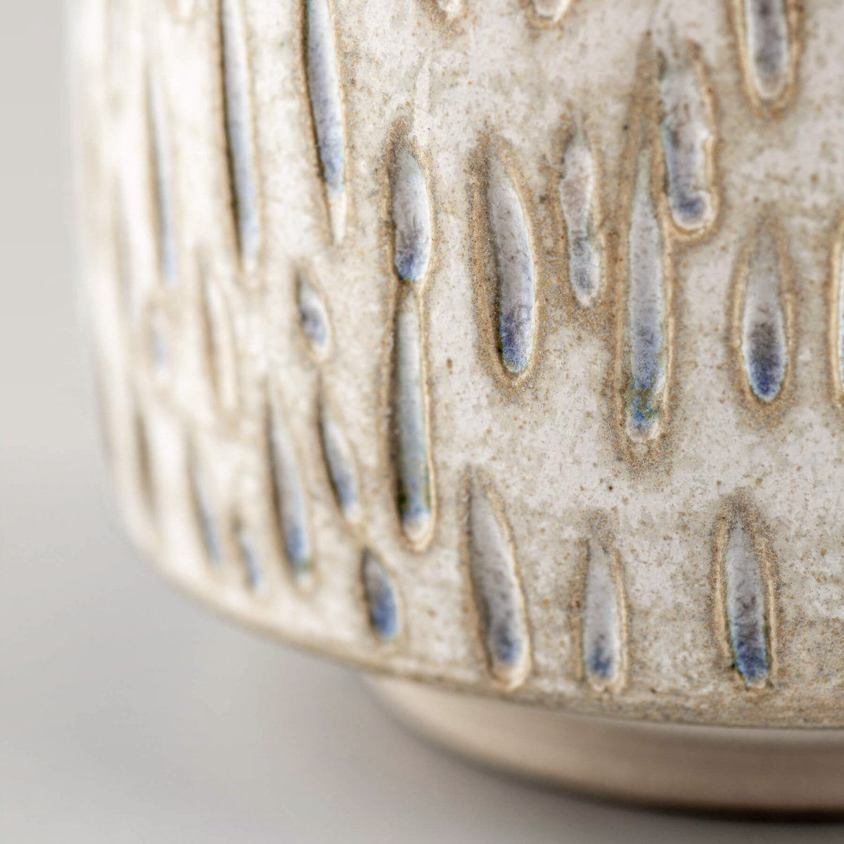 Close-up of textured ceramic espresso cup with artisanal details for restaurants and home decor.