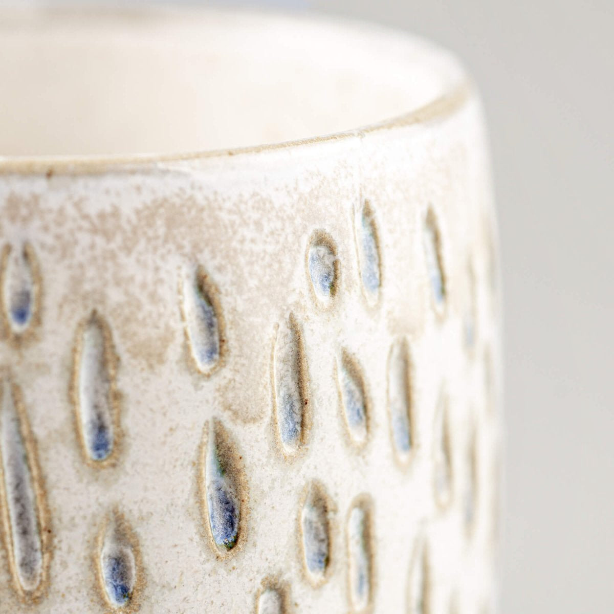 Artisan ceramic espresso cup highlighting unique handmade texture and interior design value.