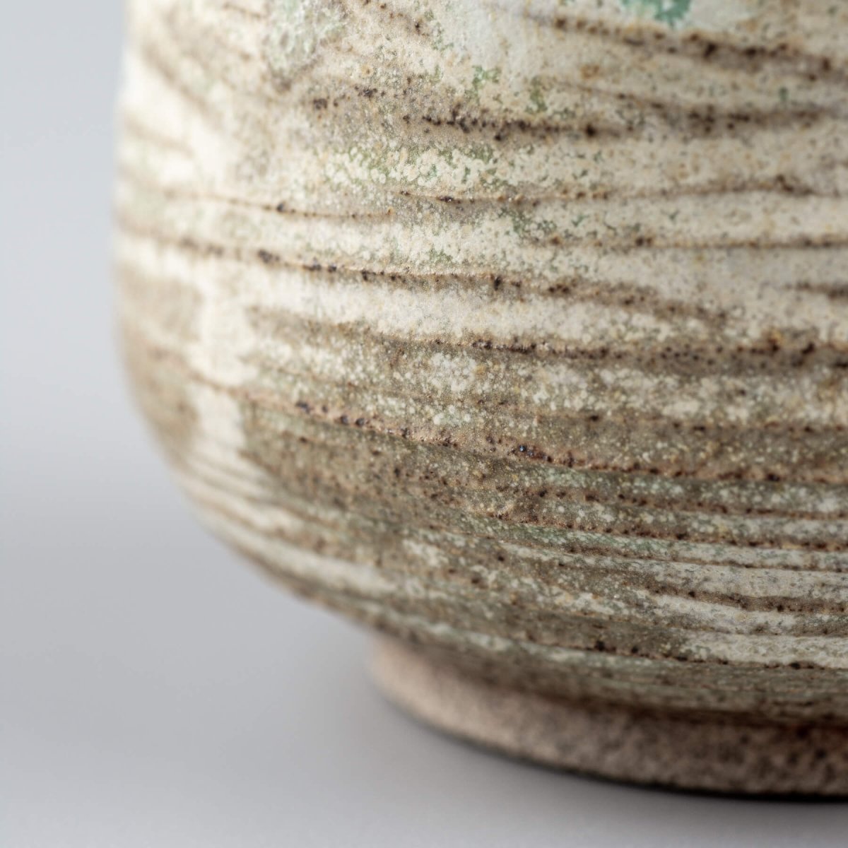 Detail of artisan ceramic mug with textured glaze for restaurants and private collectors.