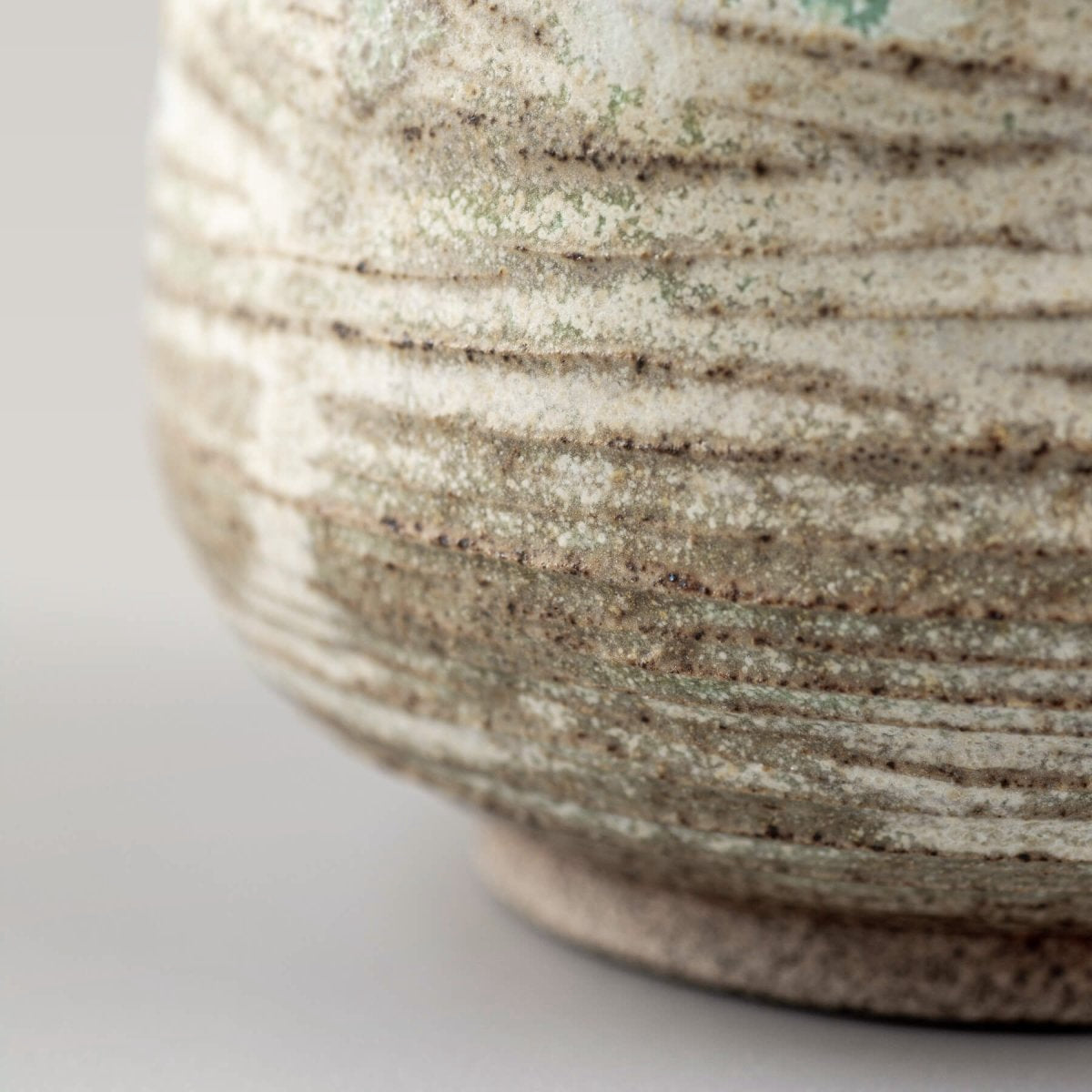 Detail of artisan ceramic mug with textured glaze for restaurants and private collectors.