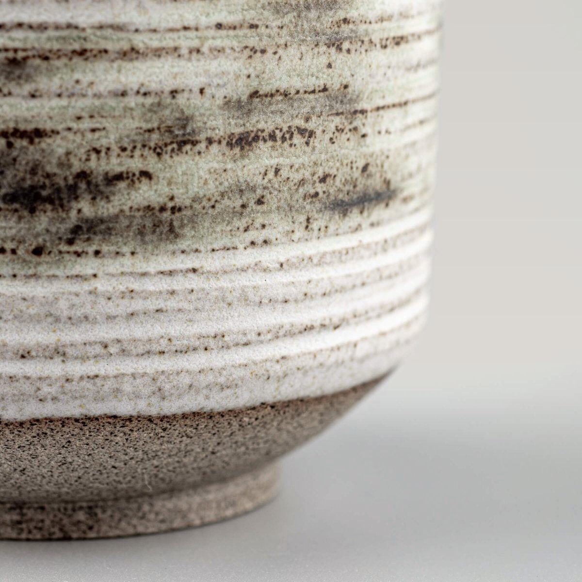 Rustic pottery mugs with white glaze, designed for culinary presentation and gifting.