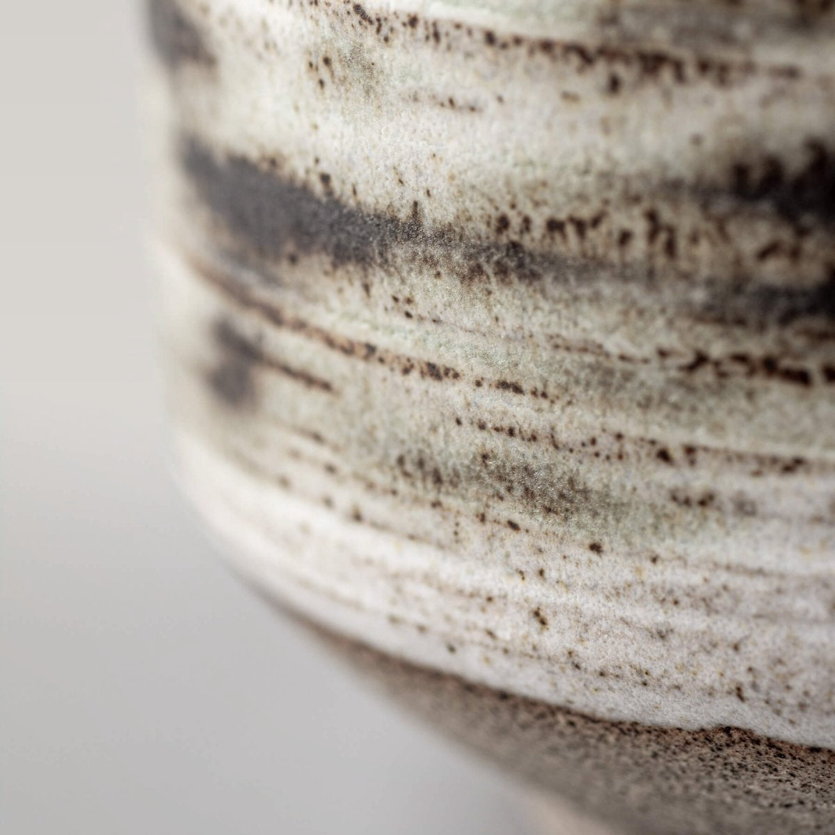 Contemporary pottery mugs with artistic carved design and matte finish.