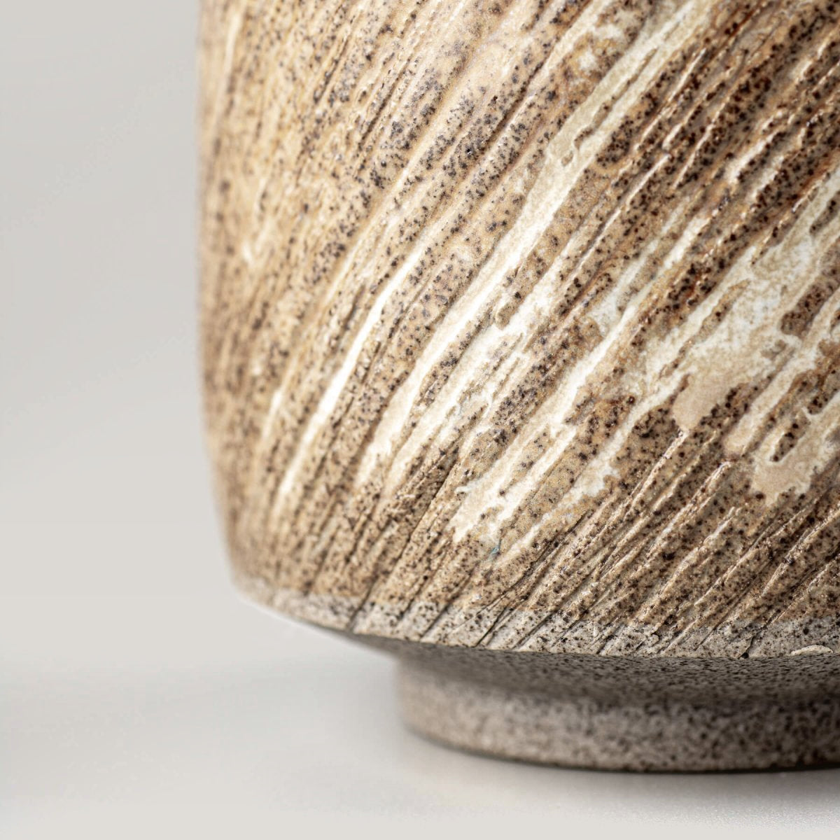 Textured handmade ceramic mugs with rustic matte glaze, crafted for everyday use and culinary presentation.