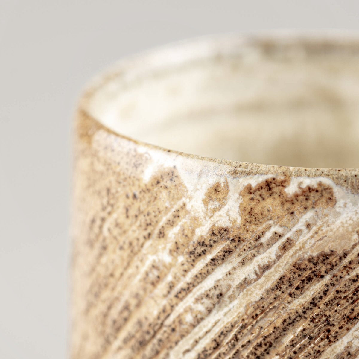 Rustic handmade ceramic mugs with textured carving, collectible pottery for private collectors.