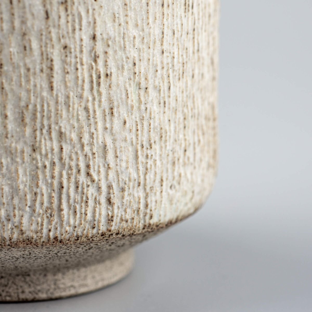 Detail of pottery mug rim with matte glaze, highlighting artisanal design.