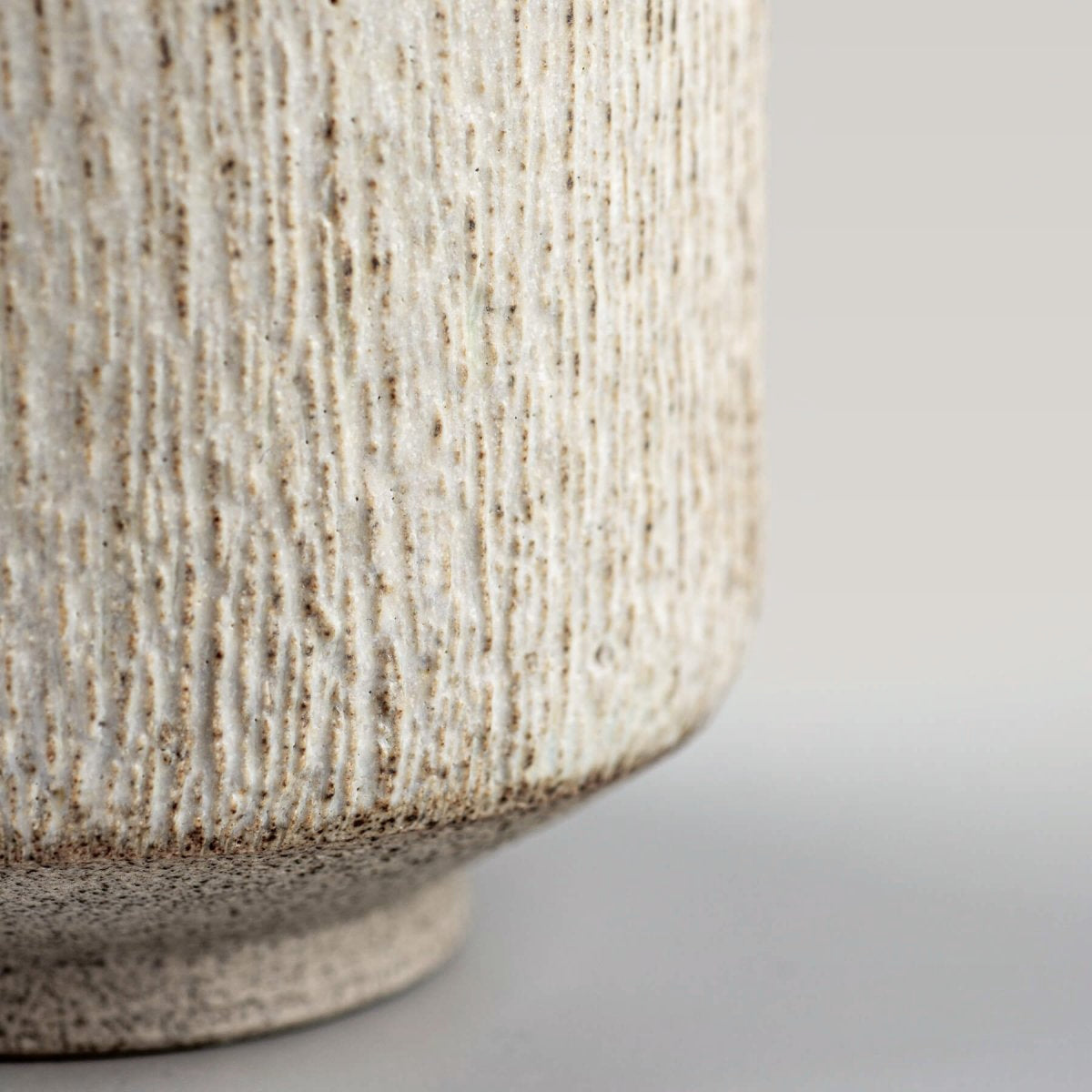 Detail of pottery mug rim with matte glaze, highlighting artisanal design.