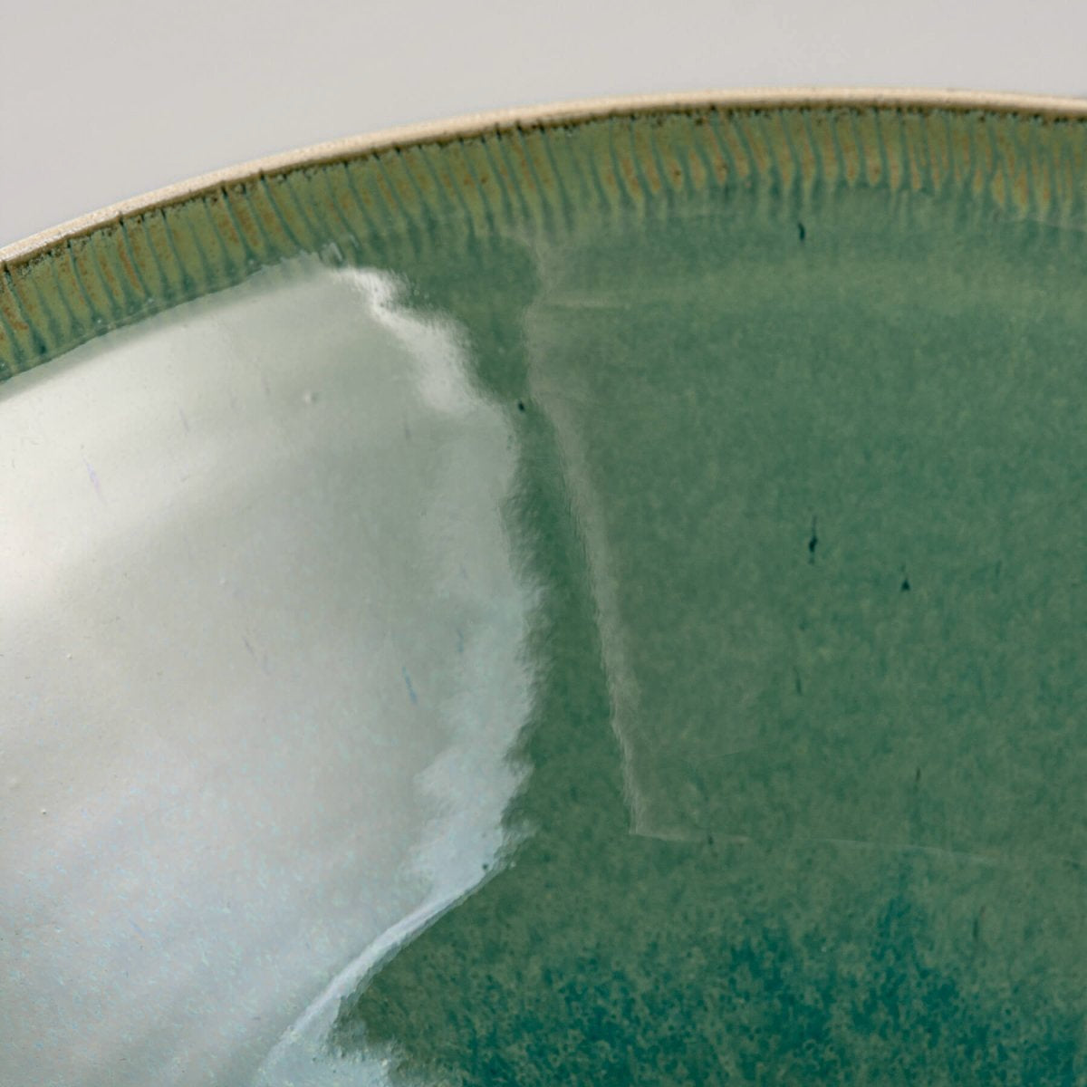 Interior close-up of bowl showing vibrant green glossy finish and smooth texture.