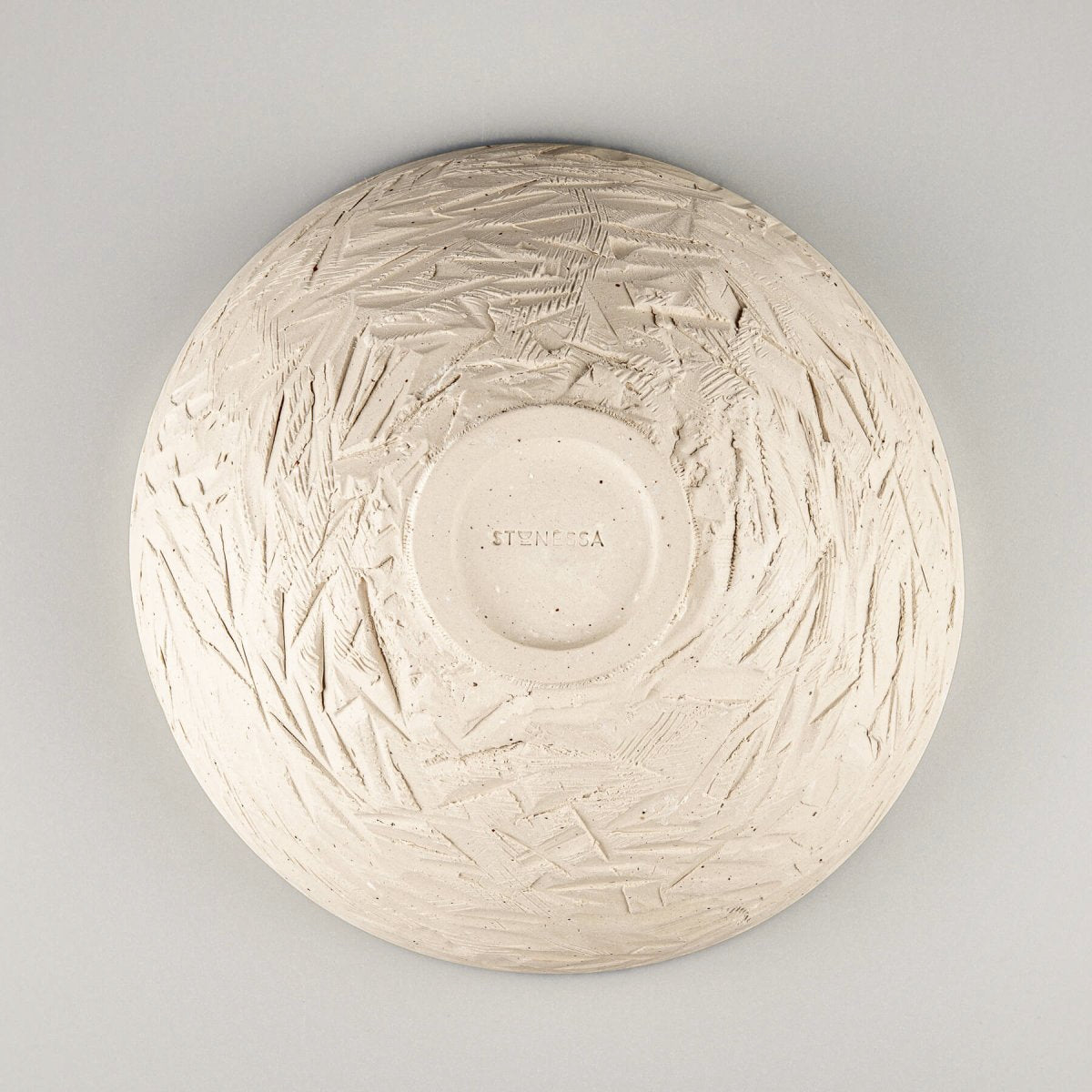 Top-down view of ceramic serving bowl highlighting central spiral and color depth of glaze.