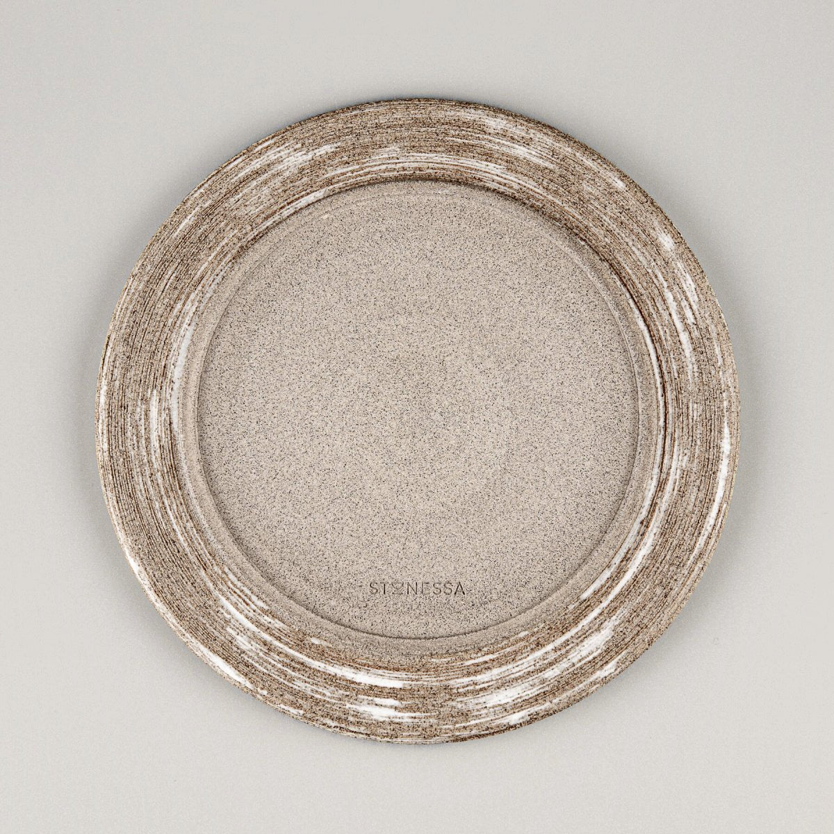 Hand-carved base of handmade ceramic plate showcasing natural clay texture and artisanal craftsmanship.