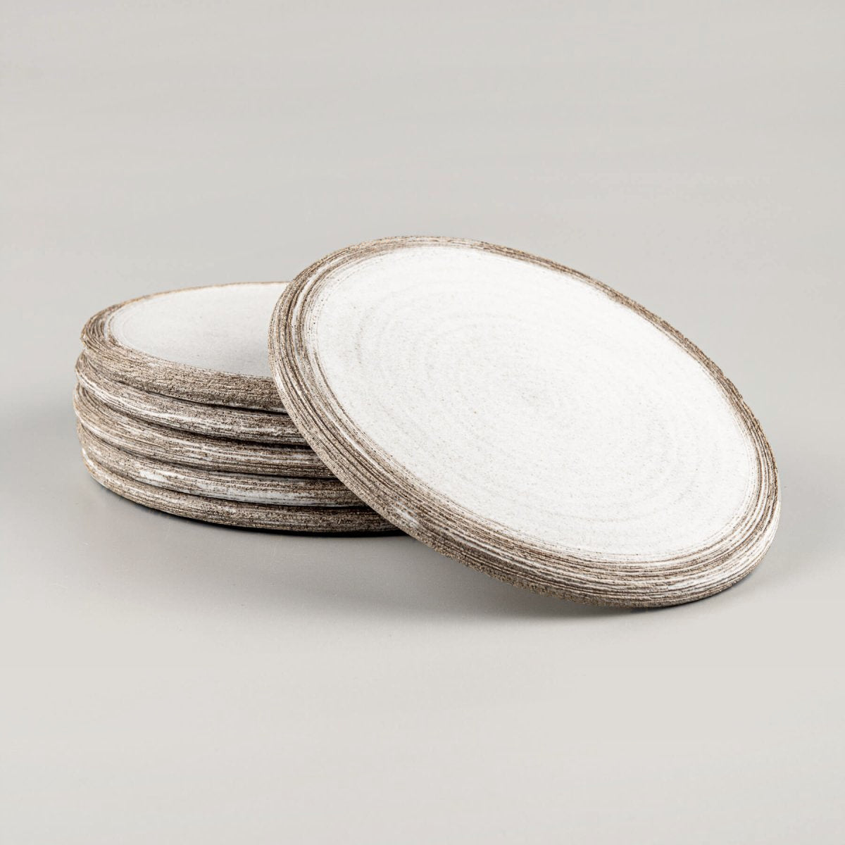 Stack of luxury handmade ceramic plates with minimalist design for premium culinary presentation.