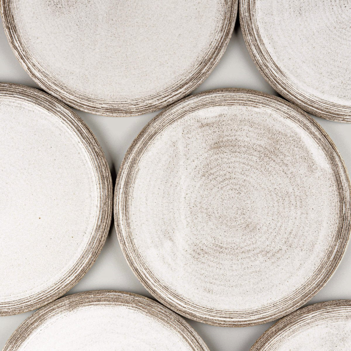 Set of artisanal ceramic plates with minimalist, elegant design for gourmet plating.