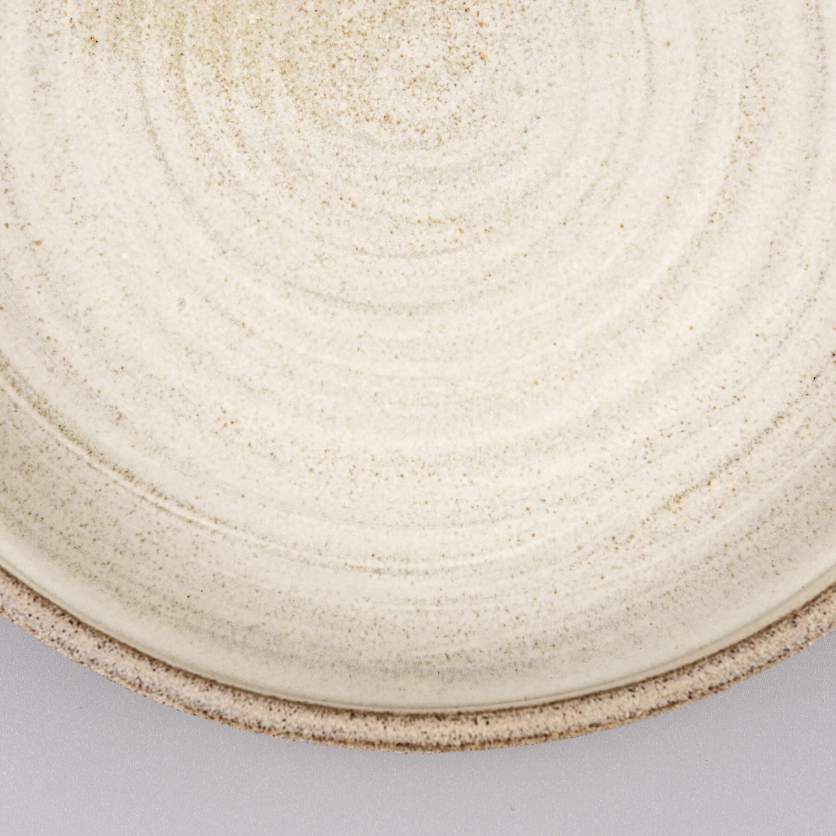 Minimalist stoneware dinner plate with natural clay and modern profile.