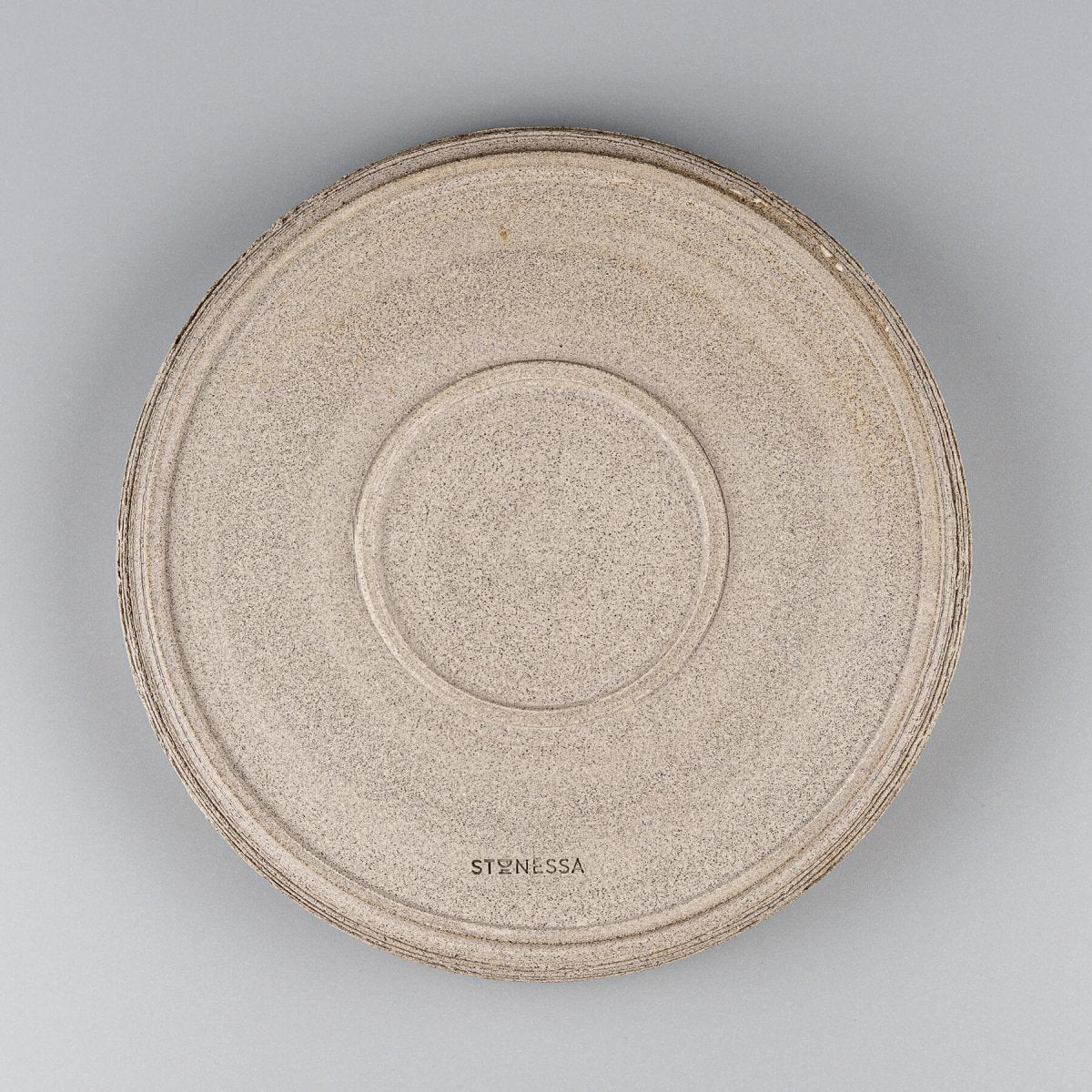 Underside view of handmade stoneware dinner plate with natural textured finish.