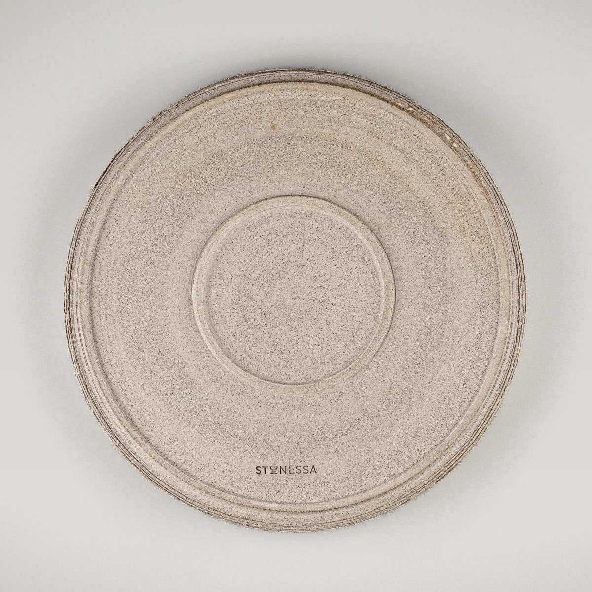 Underside view of handmade stoneware dinner plate with natural textured finish.