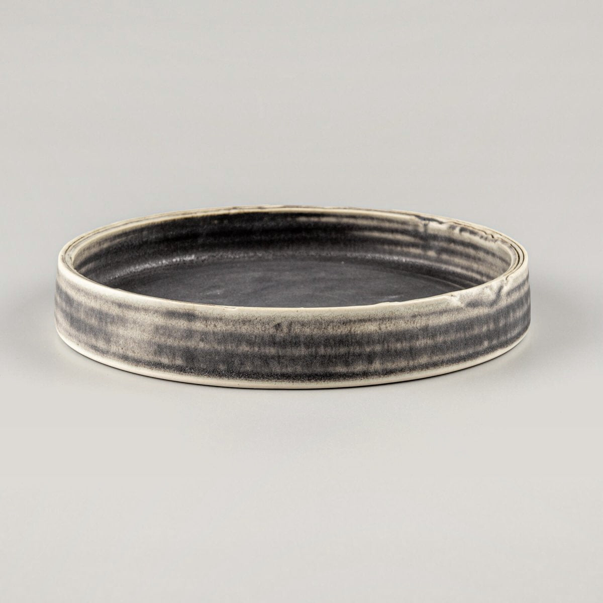 Elegant handmade ceramic plate with deep olive-green glaze and straight edges, perfect for fine dining presentation.