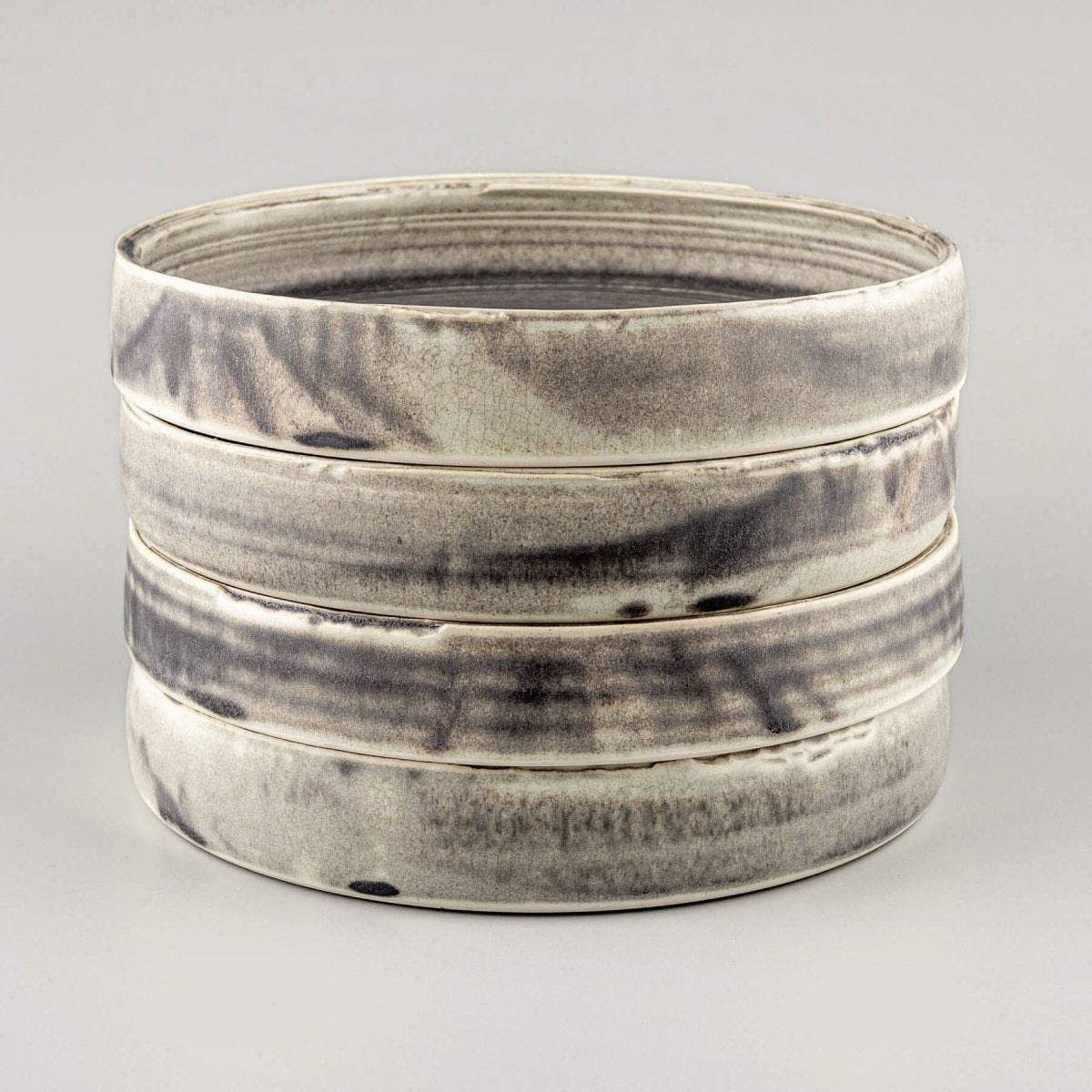 Stack of handmade ceramic plates designed for premium dining experiences in restaurants and boutique hotels.