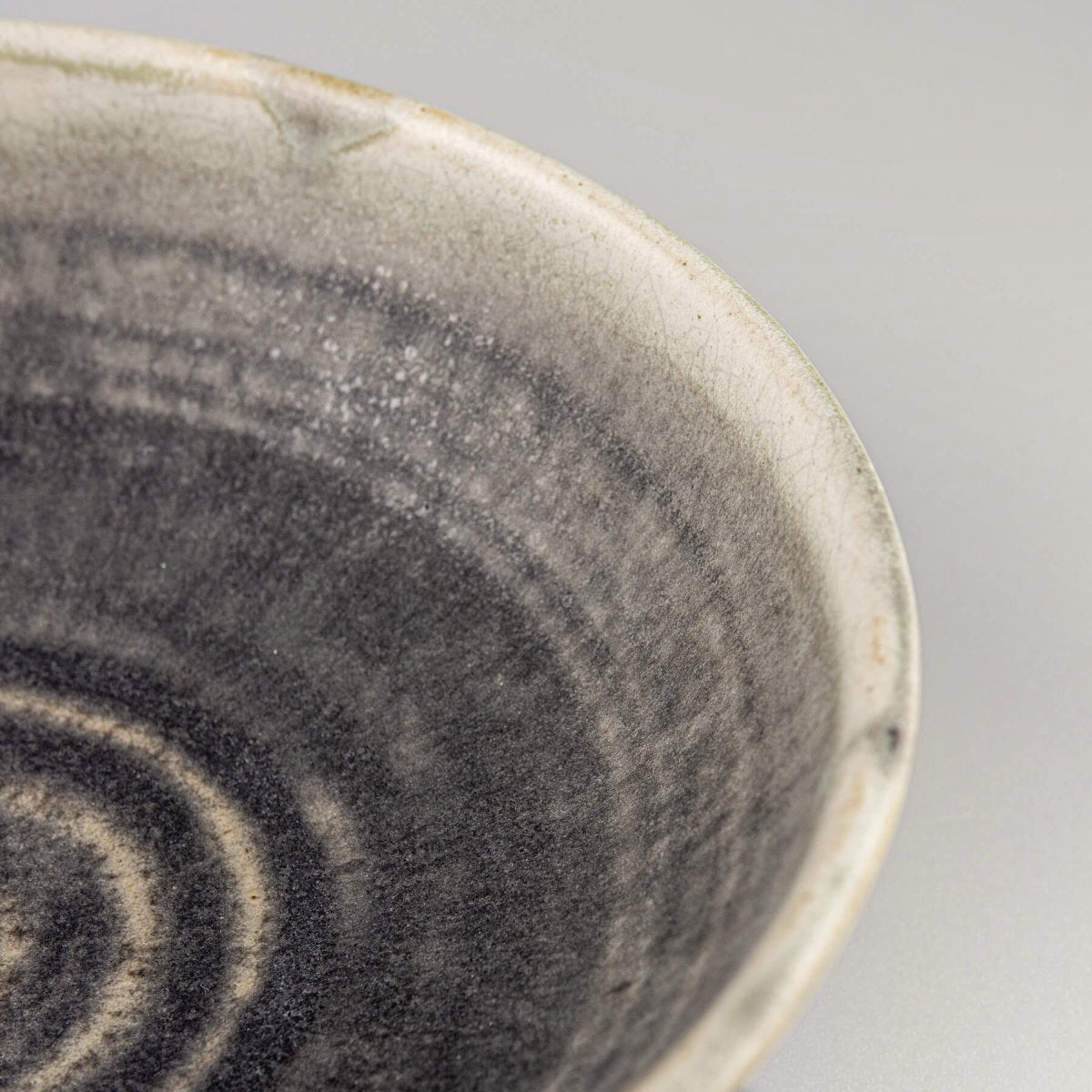 Hand-thrown ceramic bowl with carved details and green finish, excellent for kitchenware and home settings.