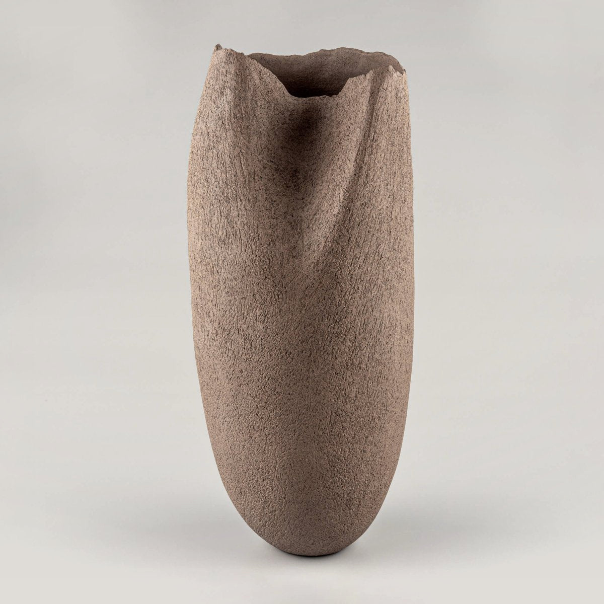 Handmade stoneware vase with a sculptural, organic shape, perfect for a hotel or restaurant's centerpiece.