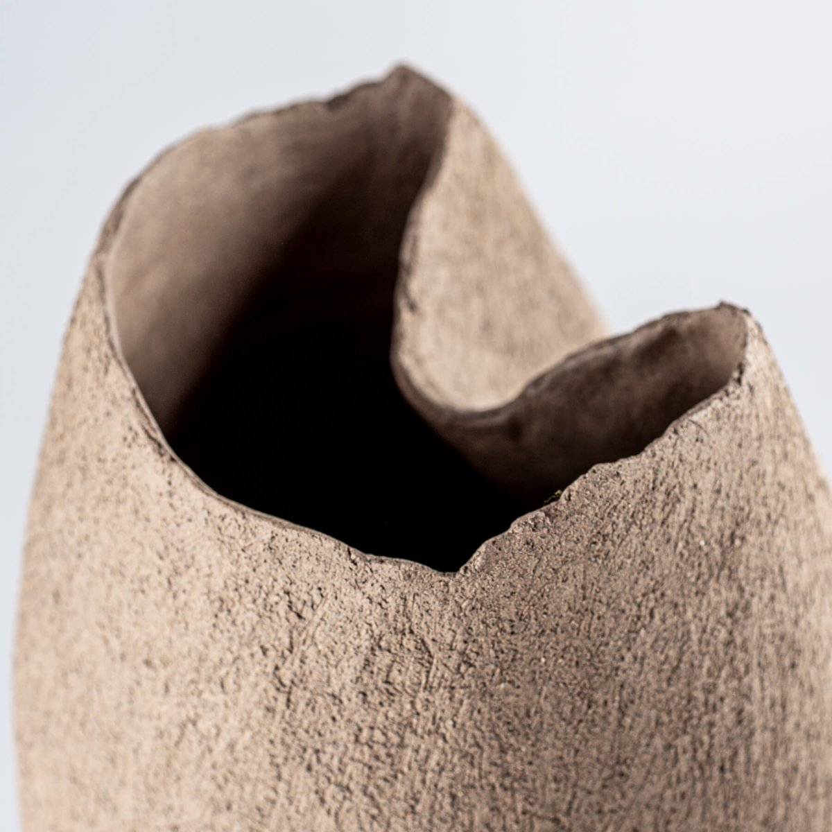 Top view of a decorative stoneware vase, showcasing an organic, unglazed finish for interior styling.