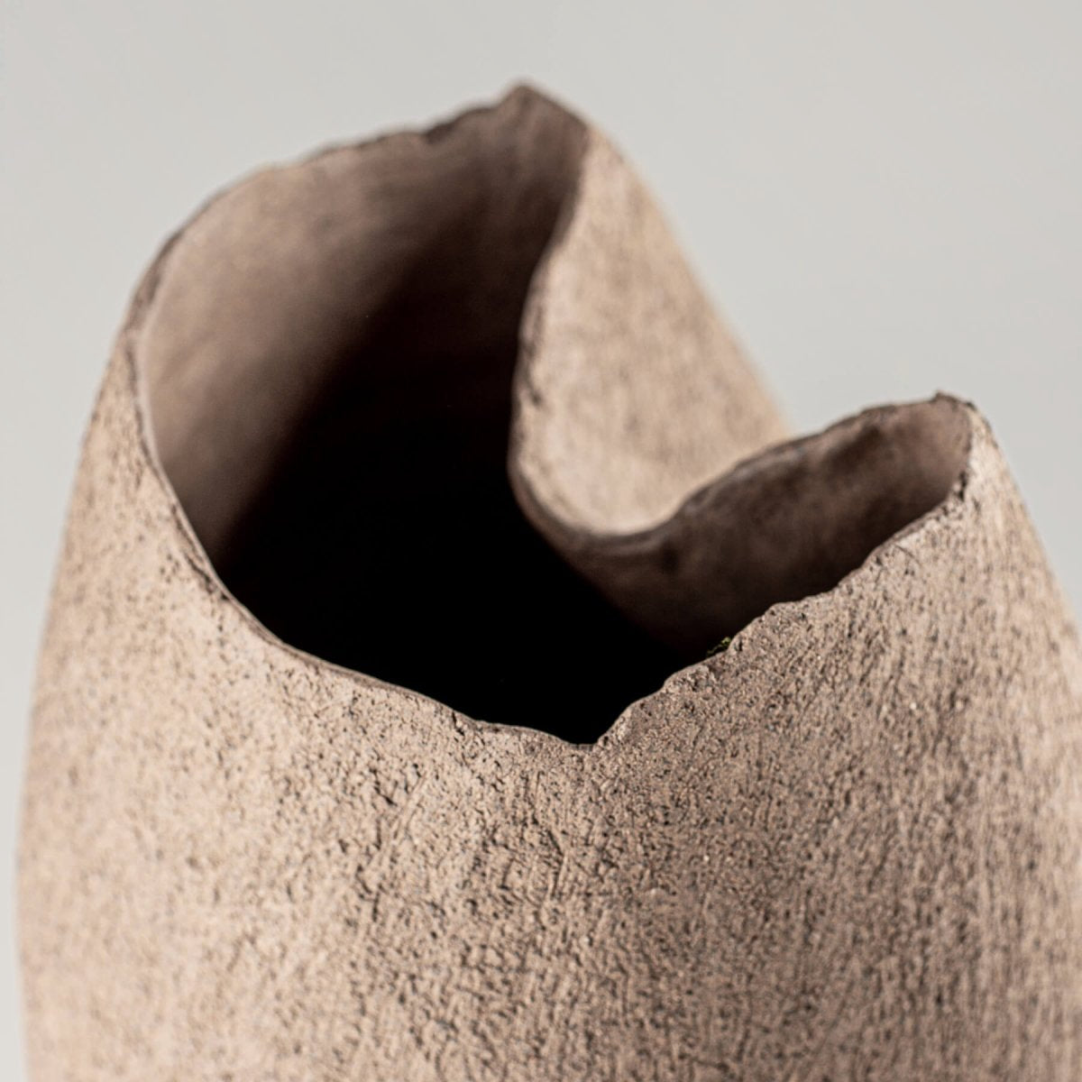Top view of a decorative stoneware vase, showcasing an organic, unglazed finish for interior styling.